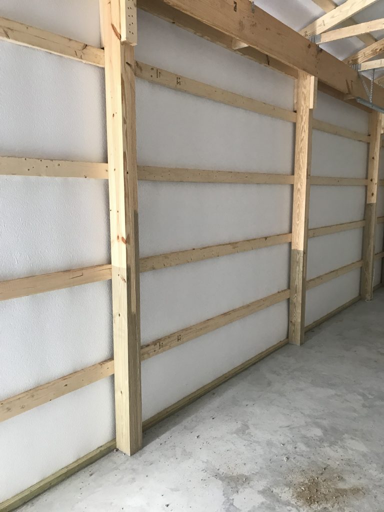 wooden pole beams lining new garage